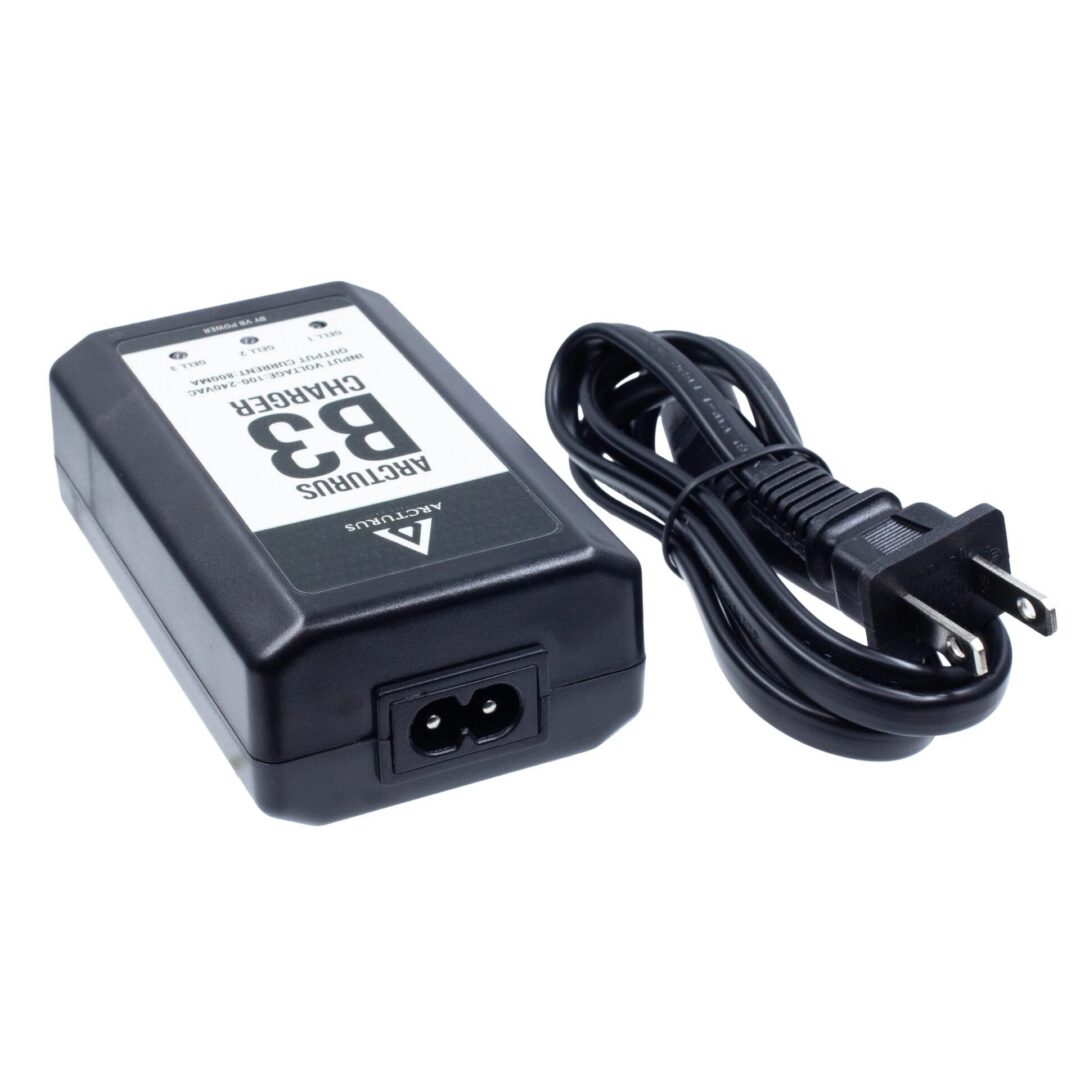 Black battery charger for the Arcturus LWT MK-III Carbine 12″ SPORT AEG SE® Black Starter Pack, featuring a coiled power cord and a two-prong wall plug.
