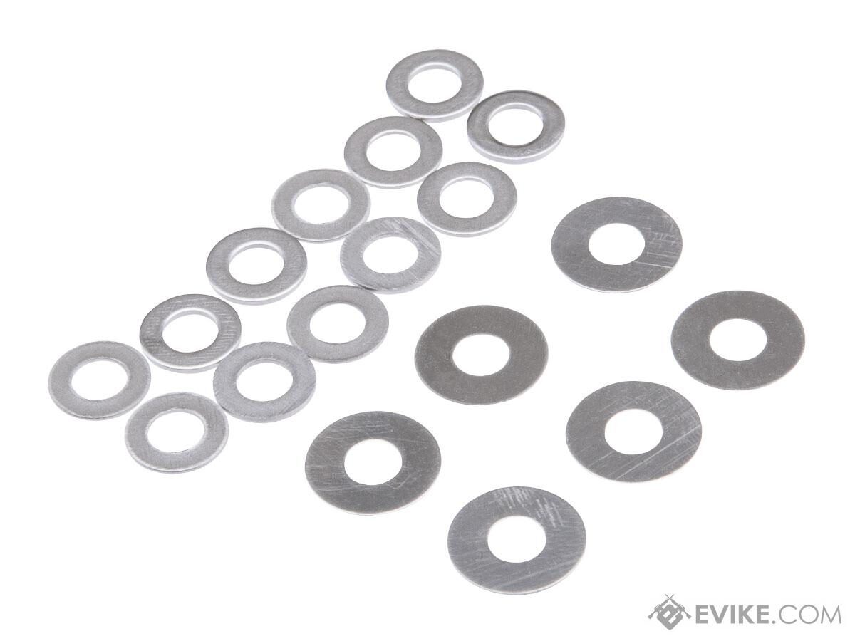A Guarder Steel Shim Set for Airsoft AEG Gearboxes consisting of circular metal shims arranged in two groups.