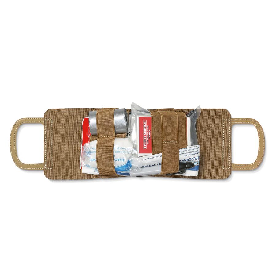An ACETAC R.A.T.S. Rapid Aid Trauma Sleeve - Multicam in tan laid flat, secured with elastic straps over assorted first aid supplies including a bandage, medical tape, and a packaged nasal airway.