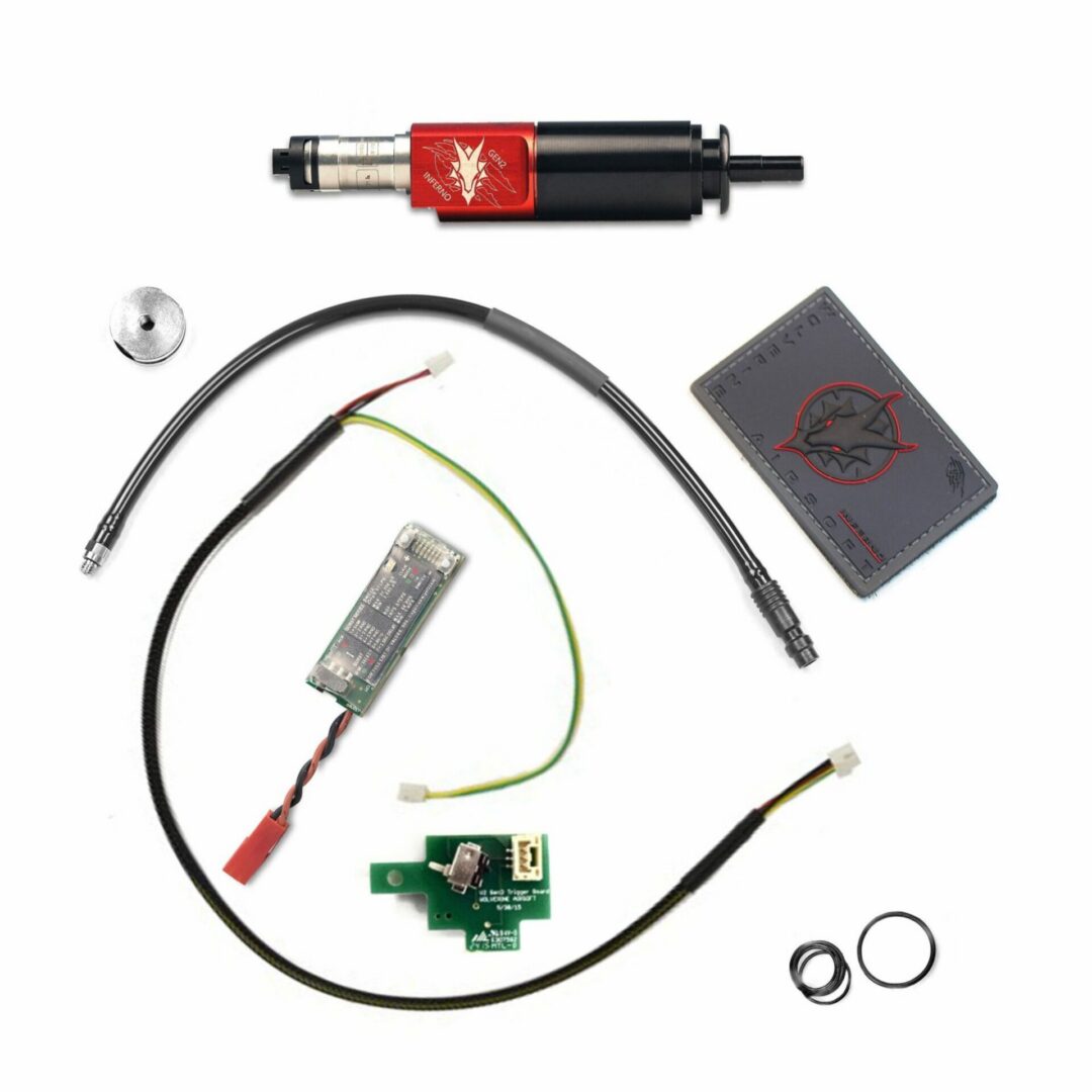 Wolverine Airsoft Inferno GEN 2 for M4 - Premium Edition components, including a cylindrical engine unit, air hose, wiring harness, trigger board, metal disc, rubber O-rings, and a branded patch.