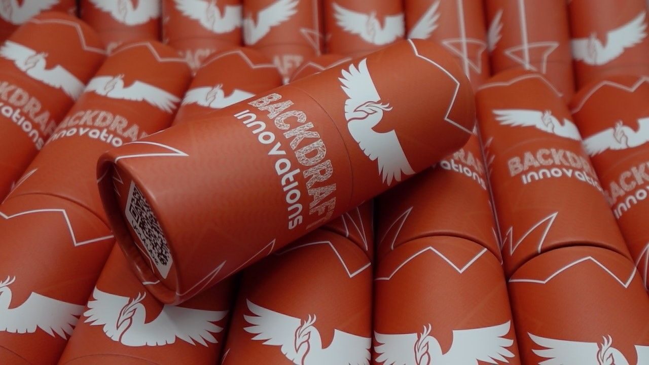 A stack of orange cylindrical containers labeled “Backdraft Phoenix M4 HPA Engine + FCU” with a white phoenix logo on each, placed closely together.
