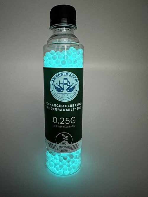 A clear plastic bottle filled with glowing light-blue airsoft pellets, featuring a label that reads “HPA 0.25G FLUO (BLUE) Approx 1,500 Rds”.