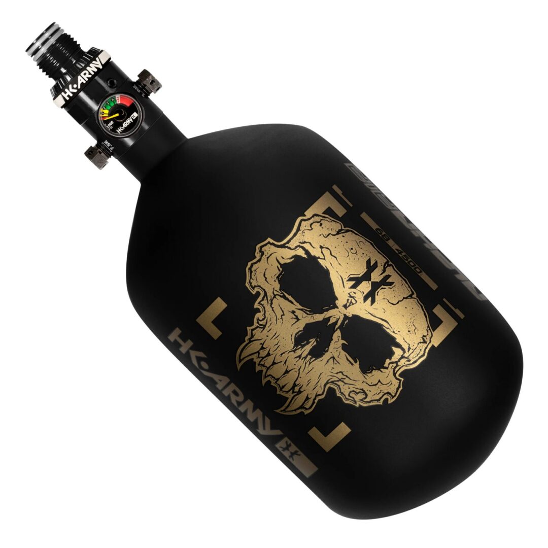 Matte black HK Army Alpha Air - 68ci/4500psi HP8 Air System paintball tank with a gold skull graphic and a pressure gauge.