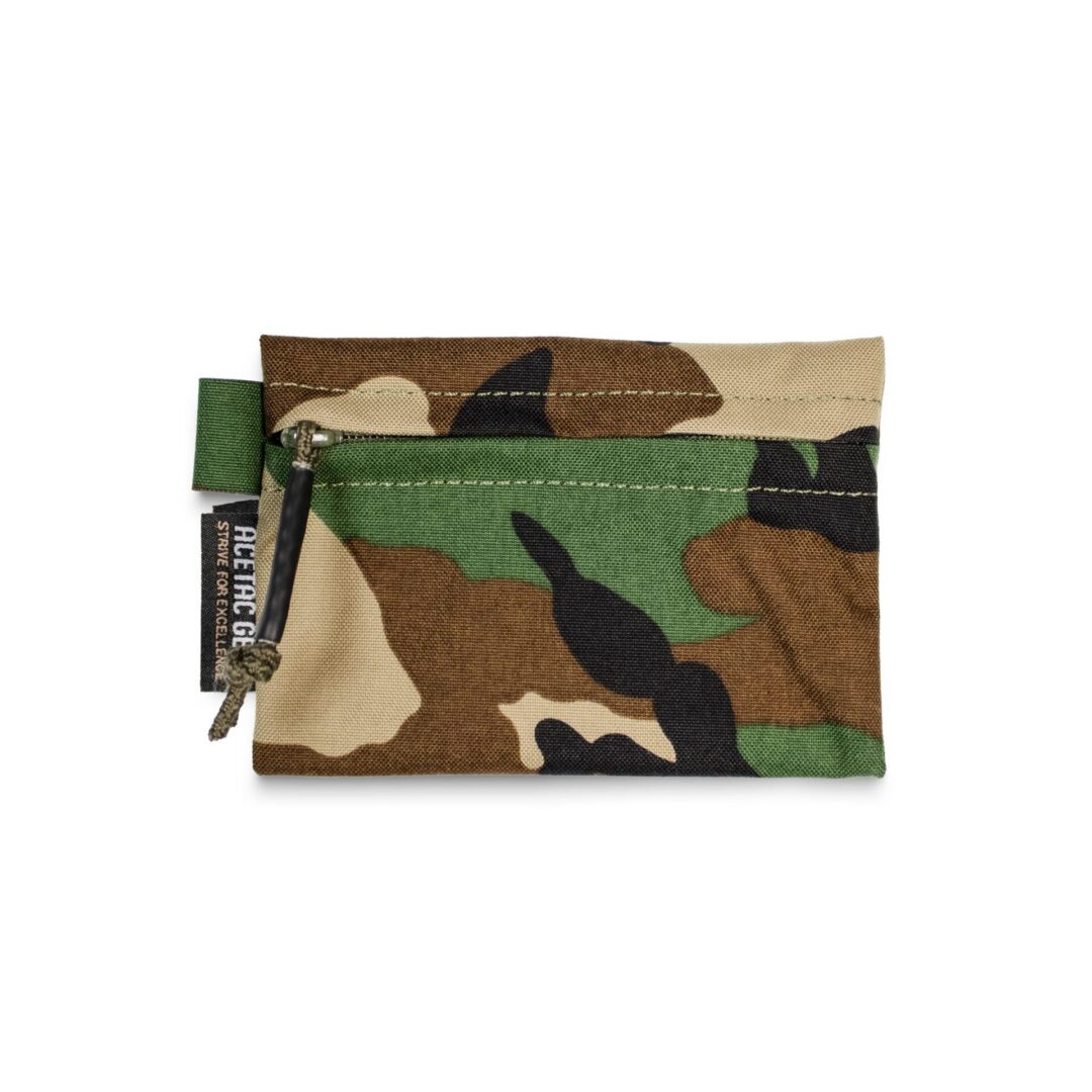 Small, rectangular Acetac Ketchall Pouch with a camouflage print and a branded fabric tag.